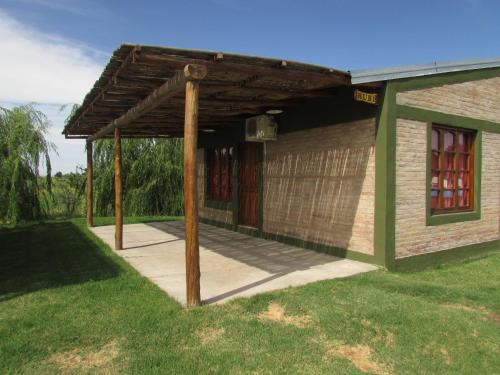 a wooden pergola on top of a house at Cabañas Las Bahienses in San Rafael