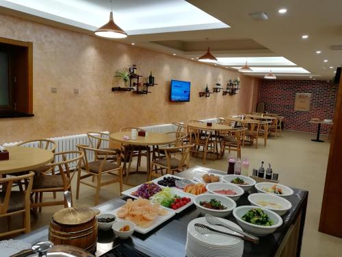 un ristorante con piatti di cibo su un tavolo di Harbin Joy Boutique Hotel a Harbin