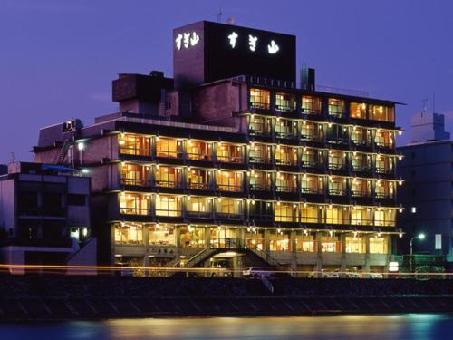 a large building with lights on in a city at Usyounoie Sugiyama in Gifu