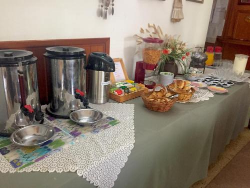 a table with a table cloth with food on it at Alpina Hostería in Villa Gesell