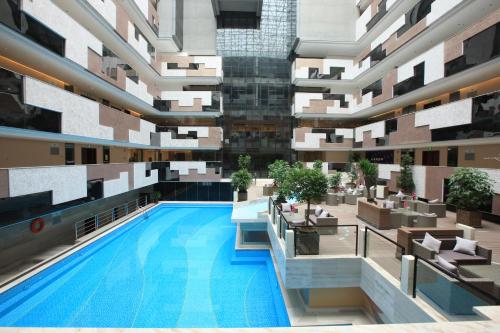 an image of a building with a swimming pool at Shenzhen Avant-Garde Hotel in Bao'an