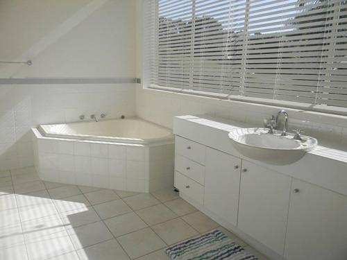een witte badkamer met een bad en een wastafel bij LIFE'S A BEACH in Mirador