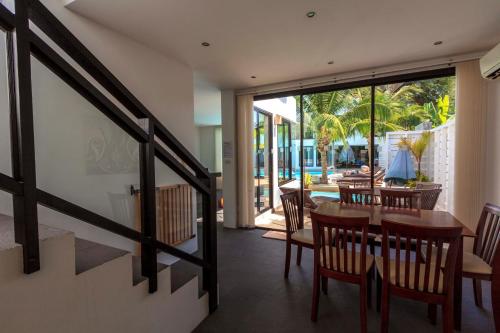 a dining room with a table and chairs and a patio at Sai Naam Lanta - Apartments & Townhouses in Ko Lanta