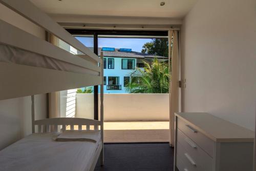 a bedroom with a bed and a view of a balcony at Sai Naam Lanta - Apartments & Townhouses in Ko Lanta