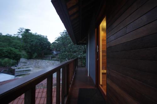 a balcony of a house with a door on it at Dava Villa Ocean View in Nusa Penida