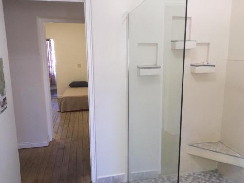 a glass door in a room with a bedroom at Paarl Backpackers in Paarl