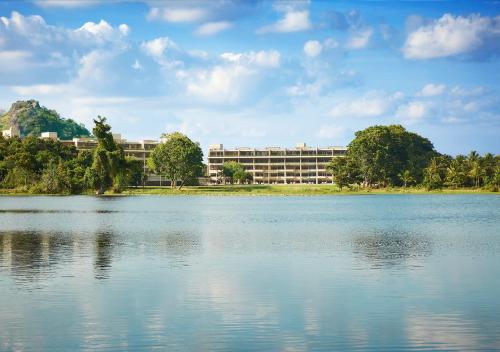 a large building in front of a large body of water at Jetwing Lake in Dambulla