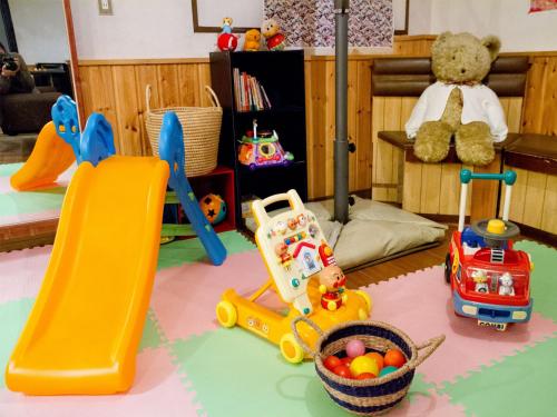 a childs play room with toys and a slide at Kagura White Horse Inn in Yuzawa