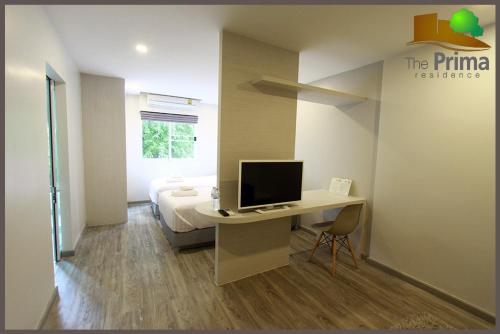 a bedroom with a desk with a computer on it at The Prima Residence - SHA Certificate in Bangkok