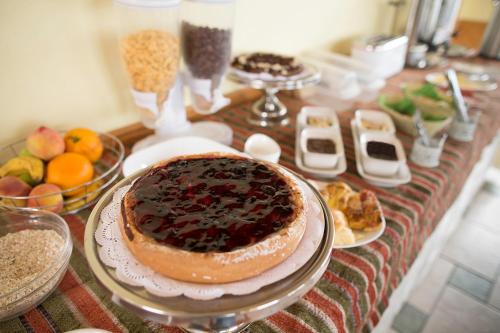 a table topped with plates of food and desserts at Hotel Carpa Manzano in Punta Arenas