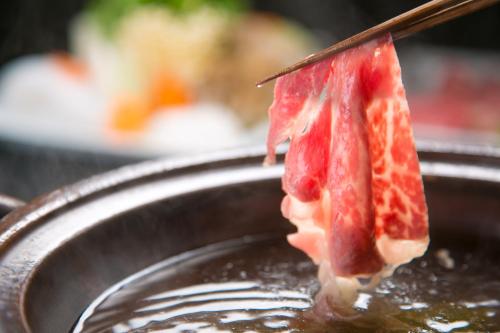 a piece of food is sticking out of a plate at Ikkoten in Yufuin