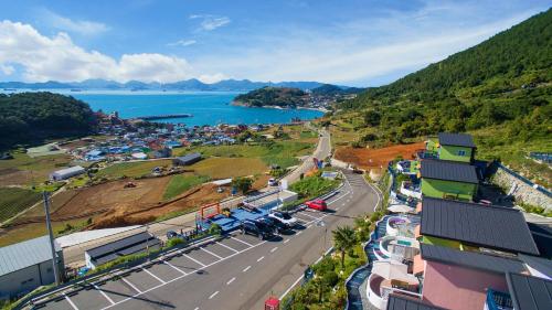 an aerial view of a town with a road and a lake at 13 Ohoo in Namhae