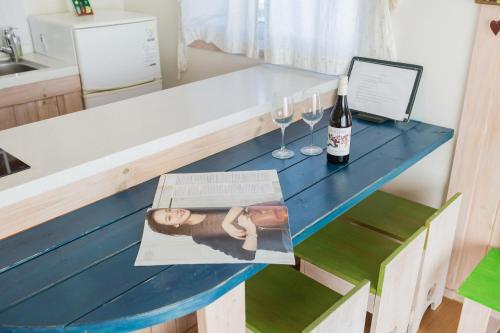 a table with a bottle of wine and a magazine at 13 Ohoo in Namhae