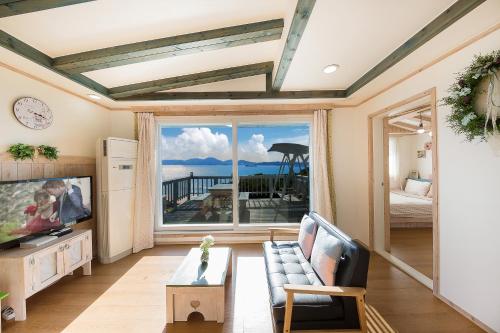 a living room with a view of the ocean at 13 Ohoo in Namhae