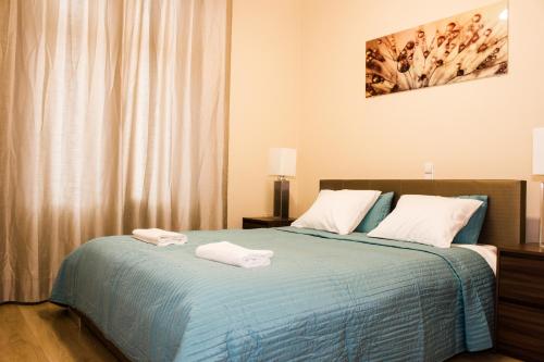 クラクフにあるSauna Luxurious Apartmentのベッドルーム1室(ベッド1台、タオル2枚付)