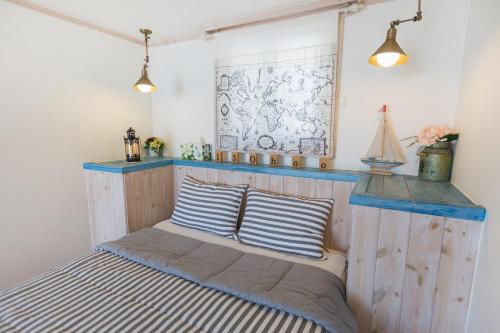 a bed in a room with two pillows on it at 13 Ohoo in Namhae