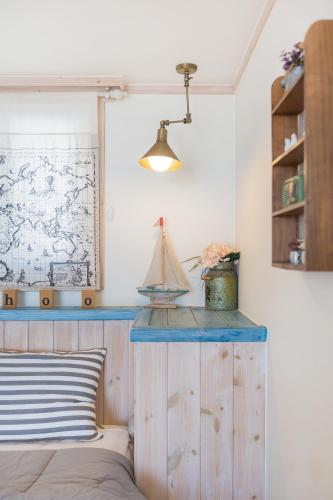 a bedroom with a blue counter with a boat on the wall at 13 Ohoo in Namhae