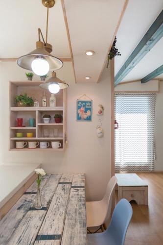 a dining room with a wooden table and chairs at 13 Ohoo in Namhae