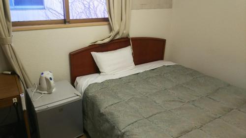 Ένα ή περισσότερα κρεβάτια σε δωμάτιο στο Itoen Hotel Hakone Yumoto