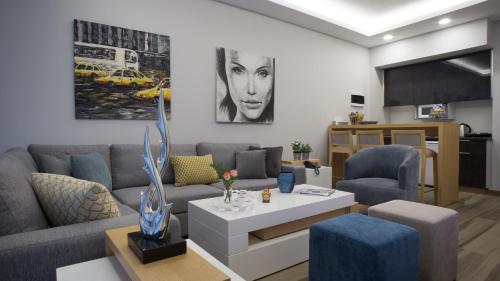 a living room with a couch and a table at The Stay Furnished Apartments in Dbayeh