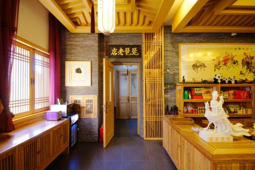 a room with a counter with a statue in it at Pipa Hotel Datong in Datong