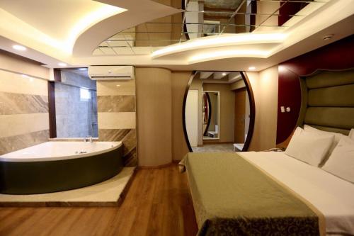 a bedroom with a bed and a bath tub at Life Corner Hotel in Izmir