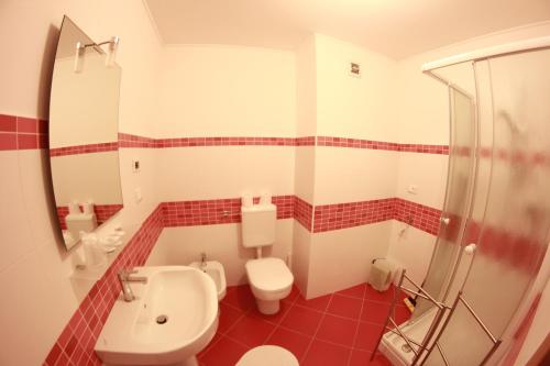a bathroom with a toilet and a sink and a shower at Residence Villa Susy in Duino