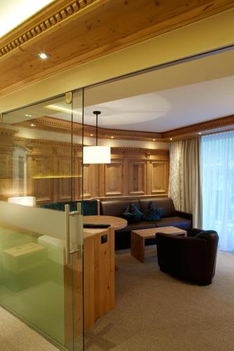 a living room with a couch and a table at Hotel Tirol in Ischgl