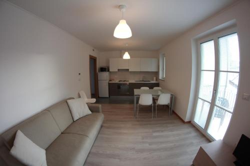 a living room with a couch and a kitchen at Residence Villa Susy in Duino