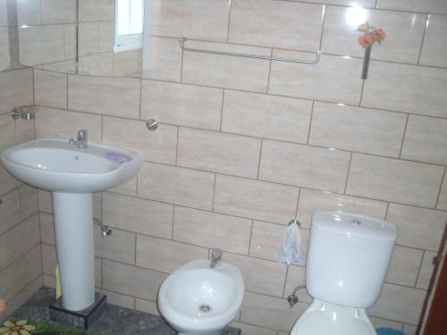 a bathroom with a toilet and a sink at Casa Bianca in Lajes das Flores