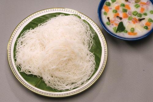 a plate of noodles and a bowl of soup at KTDC Bolgatty Palace & Island Resort in Cochin