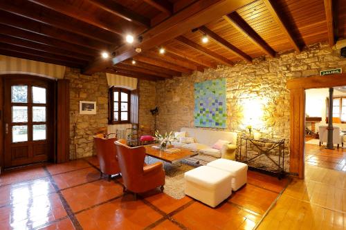 a living room with a couch and a table at La Ermita de Deva in Deva