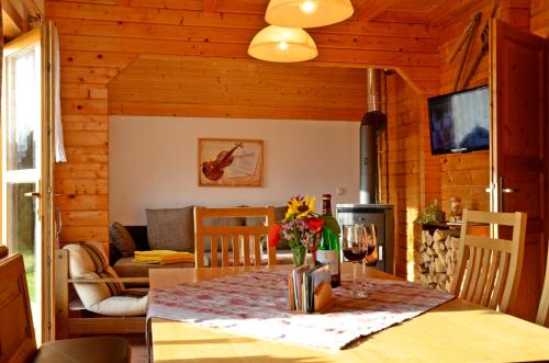 ein Esszimmer mit einem Tisch und ein Wohnzimmer in der Unterkunft Bayerwaldblockhaus in Philippsreut