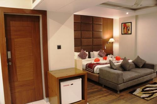 a living room with a bed and a couch at The Royal Melange Beacon in Ajmer
