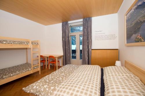a bedroom with two beds and a window at Vila Lipa in Bled