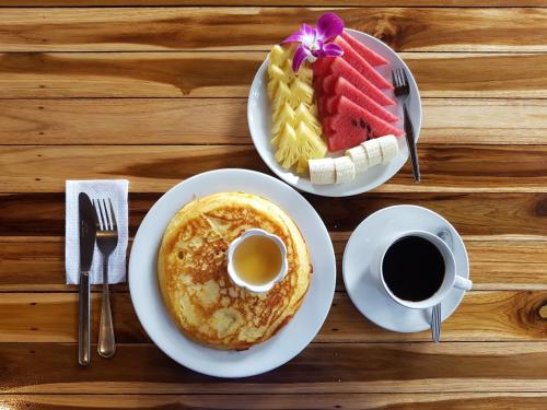 a table with two plates of food and a cup of coffee at Rapala Rock Wood Resort- SHA Plus in Railay Beach
