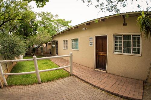 a house with a brick walkway in front of it at Horseshoe Inn and Conference Center in Kimberley