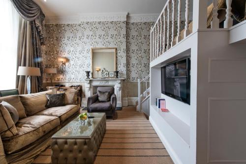 a living room with a couch and a tv at The Colonnade in London