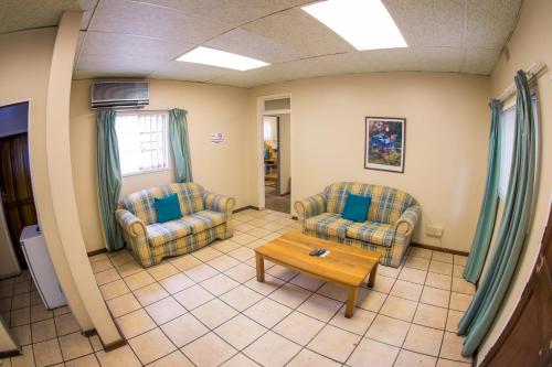 a living room with two chairs and a coffee table at Horseshoe Inn and Conference Center in Kimberley