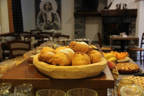 a table with a basket of bread and other foods at Residence Les Coupoles in Champoluc