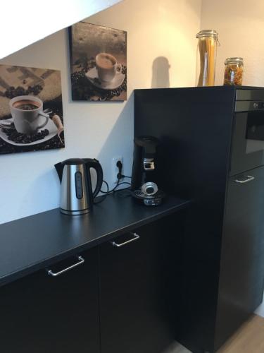 a kitchen with a black counter with a coffee maker at Apartment Gronau in Gronau