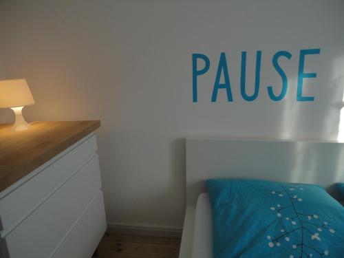 a bedroom with a bed and a pause sign on the wall at Schönerferienwohnen in Bamberg in Bamberg