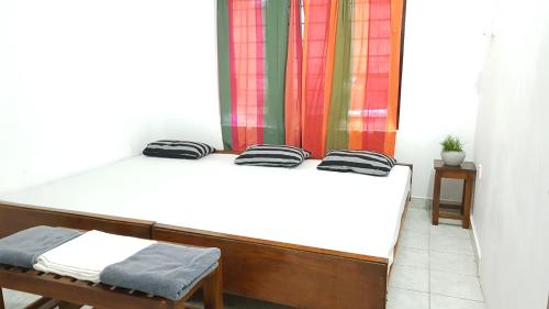 two twin beds in a room with a window at Lodge in 611 in Kandy