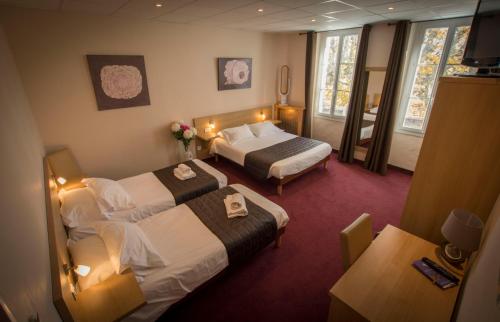 a hotel room with two beds and a balcony at Hotel Restaurant Le Castel Fleuri in Carnoules