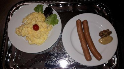 two plates of food on a tray with hot dogs and potatoes at Hotel BESTAR in Mladá Boleslav