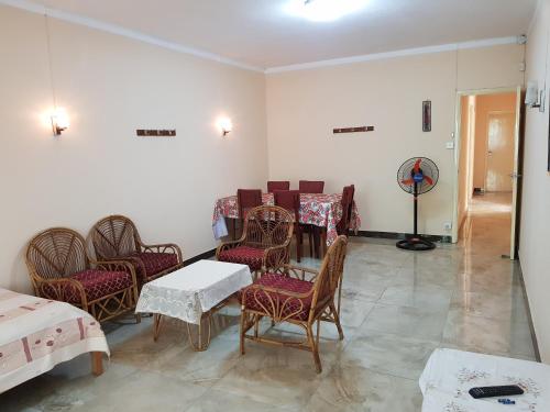 a waiting room with chairs and a table and a table and chairs at Pereybere Beach Apartments in Pereybere