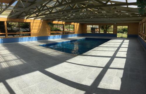 a swimming pool in a building with a large ceiling at Silver Ridge Retreat in Sheffield