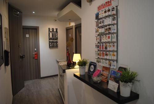 a kitchen area with a counter, a refrigerator, and a window at Hostal Abril Madrid in Madrid