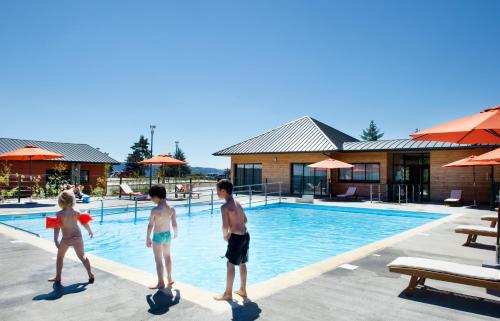 3 enfants jouant dans la piscine d'un complexe dans l'établissement Les Hauts du Gevaudan, à Montrodat