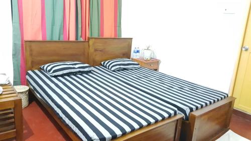 a bed with two pillows on it in a room at Lodge in 611 in Kandy